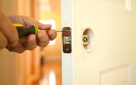 Handyman in Pine Lake, GA fixing door.